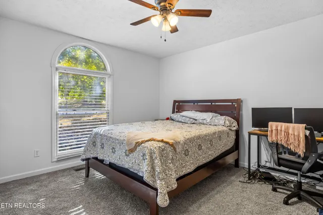 a bed sitting in a bedroom next to a window