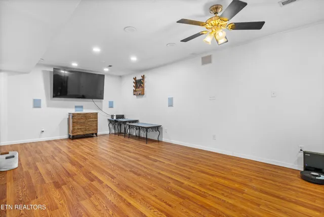 a view of an empty room with a window and a flat screen tv