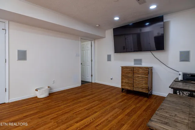 a view of empty room with wooden floor