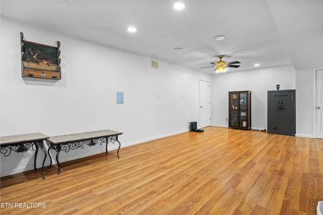 a big room with wooden floor and furniture
