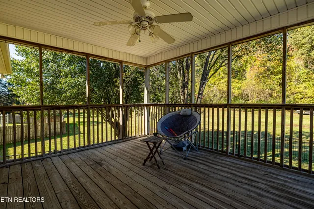 a view of balcony with wooden floor and fence