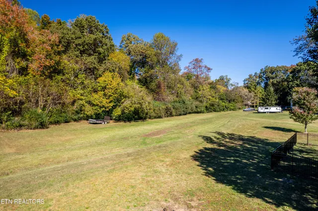 a view of a house with a yard and sitting area