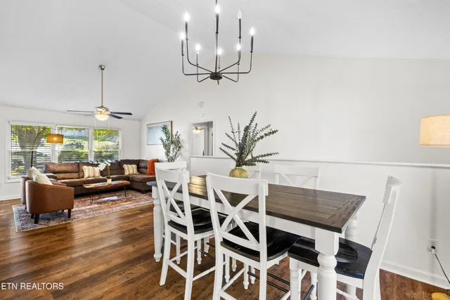 a view of a dining room with furniture wooden floor and chandelier