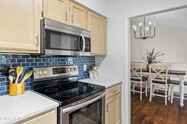 a kitchen with stainless steel appliances a stove a microwave and cabinets