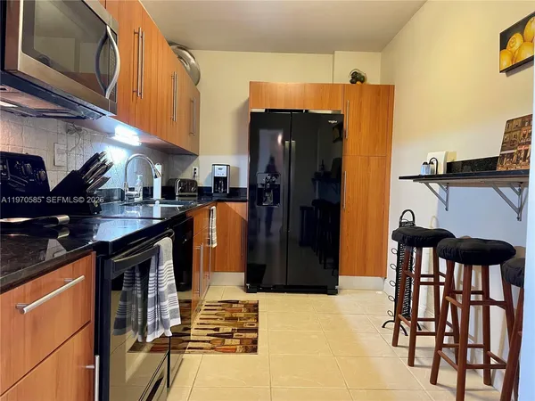 a kitchen view of a table and chairs