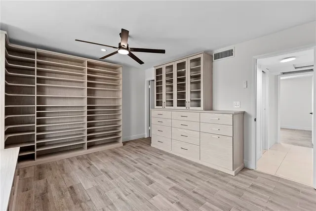 a view of room with wooden floor and windows