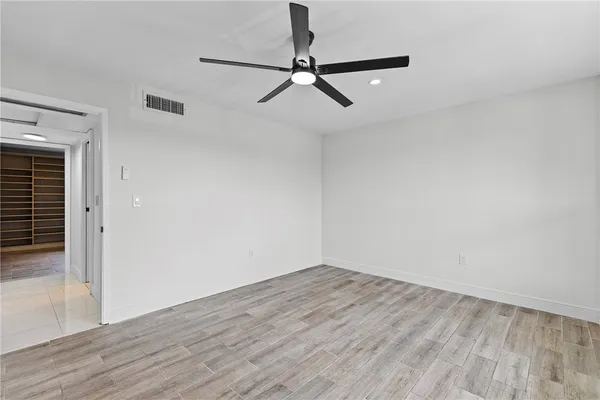 a view of a room with wooden floor and white walls