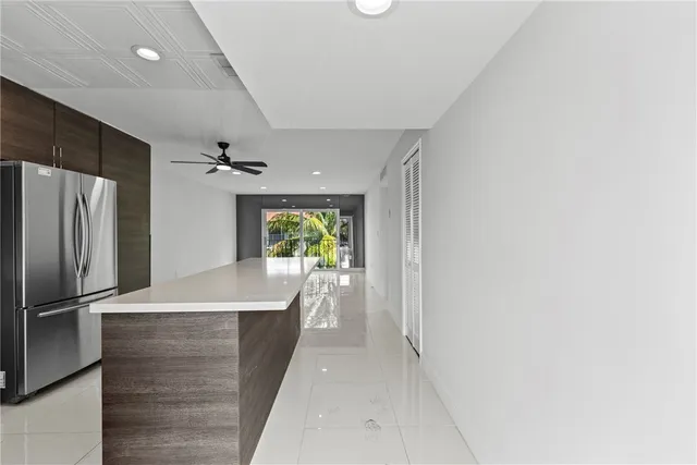 a view of a refrigerator in kitchen and wooden floor