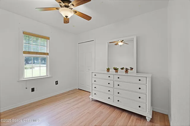 a view of a dresser with chandelier fan