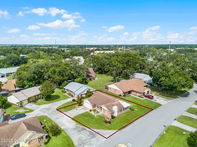 a view of a patio with furniture and a garden