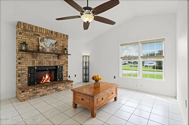 a living room with furniture a flat screen tv and a fireplace