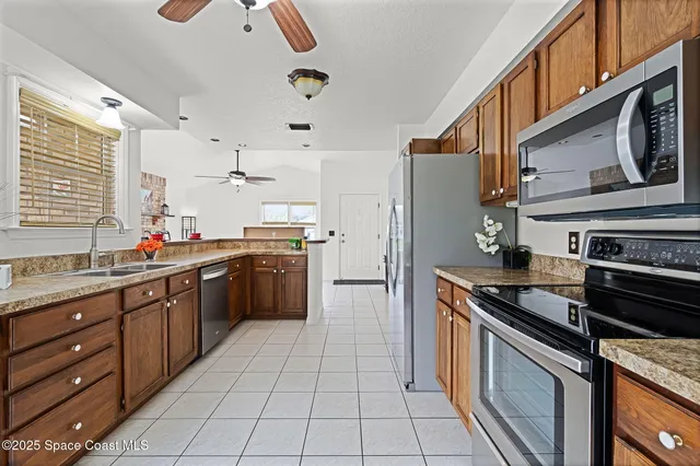 a kitchen with stainless steel appliances granite countertop a stove and a sink