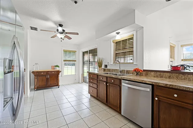 a kitchen with stainless steel appliances a sink stove and cabinets