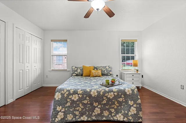 a bedroom with a bed and wooden floor