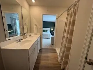 a bathroom with a double vanity sink and a mirror