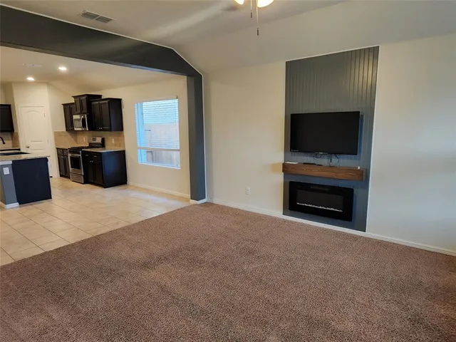 a living room with a fireplace and a flat screen tv