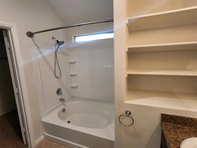 a bath tub sitting next to a white sink