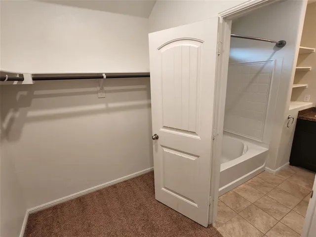 a bathroom with a granite countertop toilet sink and mirror