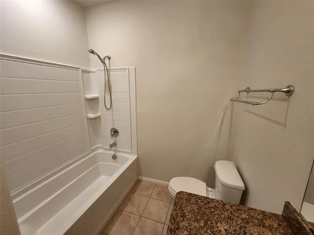 a bathroom with a granite countertop sink a mirror and shower
