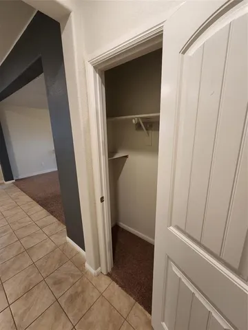 a view of hallway with a sink and a mirror