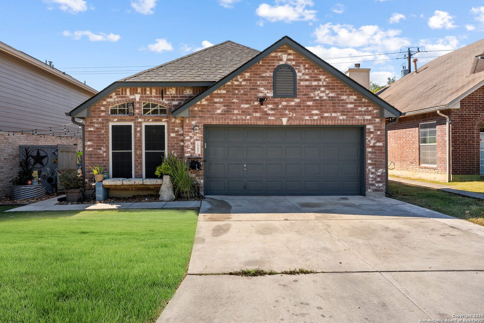 a front view of a house with a yard and garage