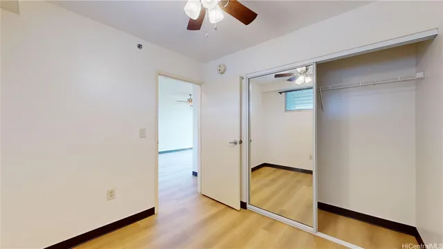an empty room with wooden floor and window