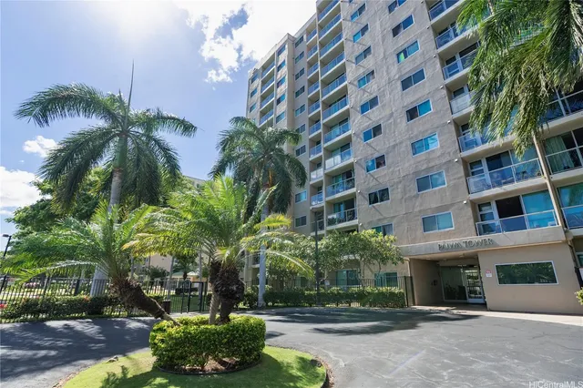 a front view of a multi story building with yard