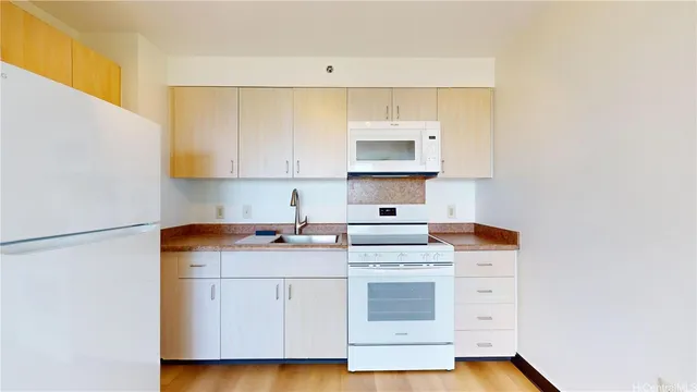 a kitchen with stainless steel appliances a stove a sink and a refrigerator