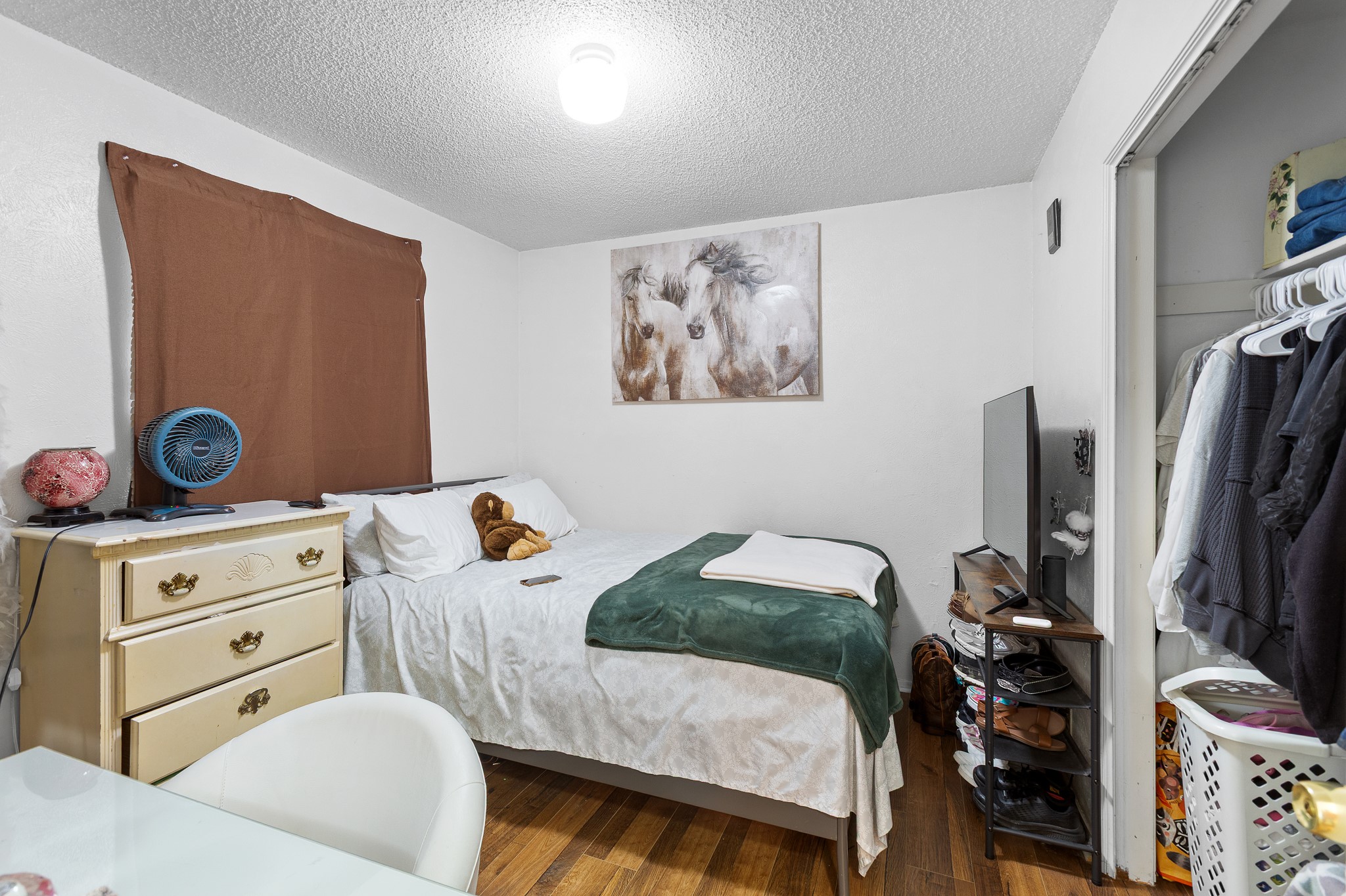 606 Misty Morning Way, Unit A AND B Round Rock, TX 78664 - Photo 16 of 22 Bedroom featuring a textured ceiling and wood finished floors