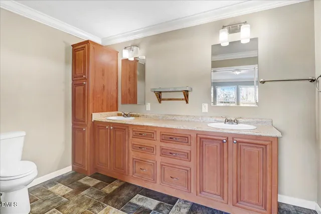 a spacious bathroom with a granite countertop sink and a mirror