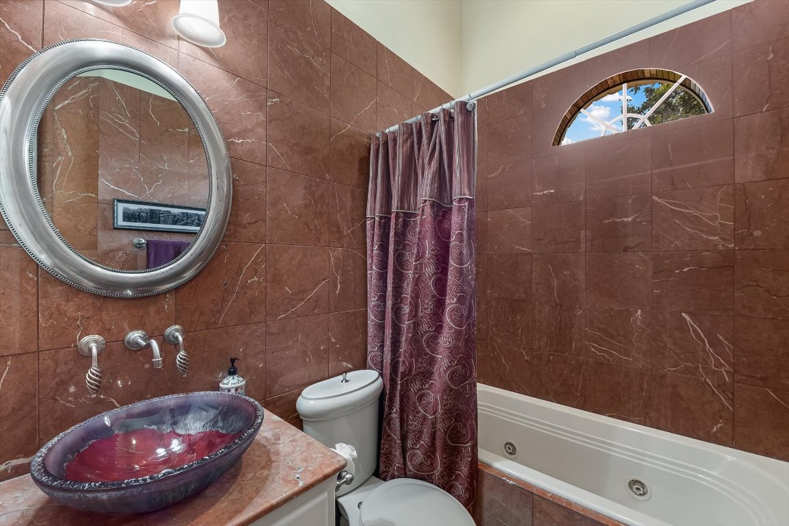 1001 Wesley Ridge Drive Spicewood, TX 78669 - Photo 12 of 35 Full bath featuring a combined bath / shower with jetted tub and tile walls
