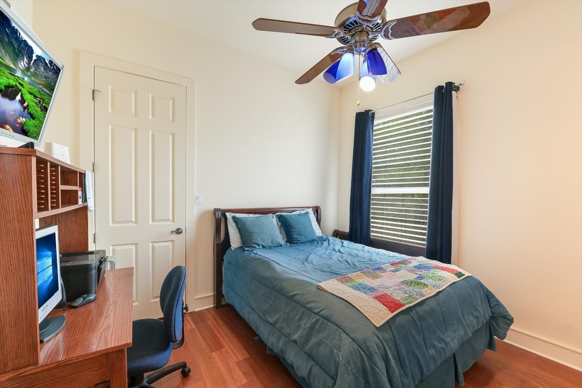 1001 Wesley Ridge Drive Spicewood, TX 78669 - Photo 14 of 35 Bedroom with wood finished floors and a ceiling fan