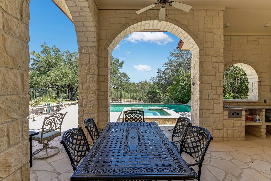 1001 Wesley Ridge Drive Spicewood, TX 78669 - Photo 19 of 35 View of patio / terrace with outdoor dining space, ceiling fan, and view of wooded area
