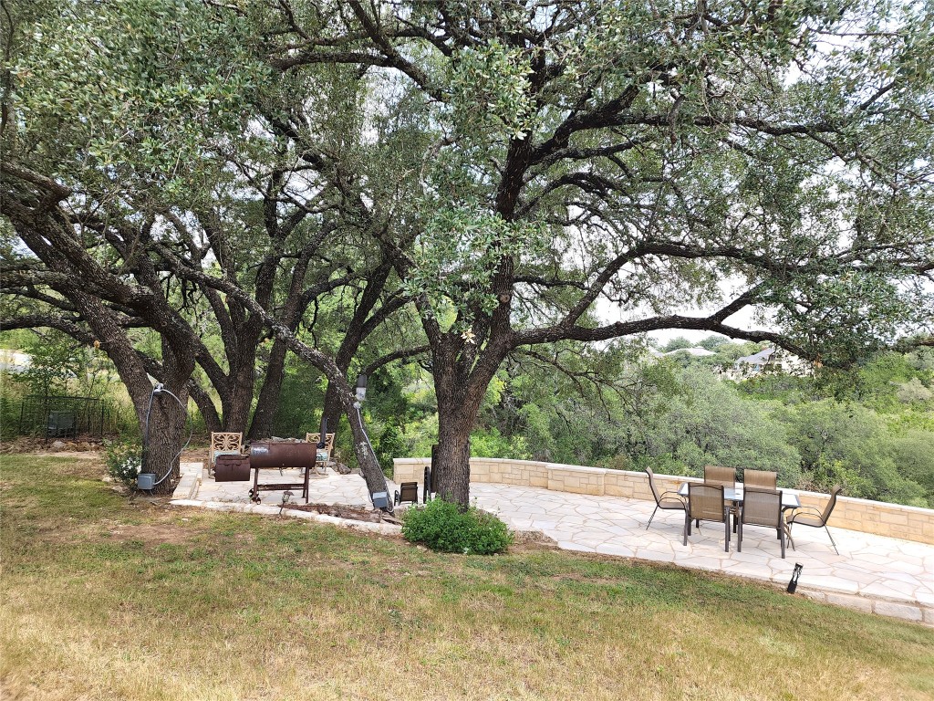 1001 Wesley Ridge Drive Spicewood, TX 78669 - Photo 28 of 35 Stone entertainment patio with Hill Country views