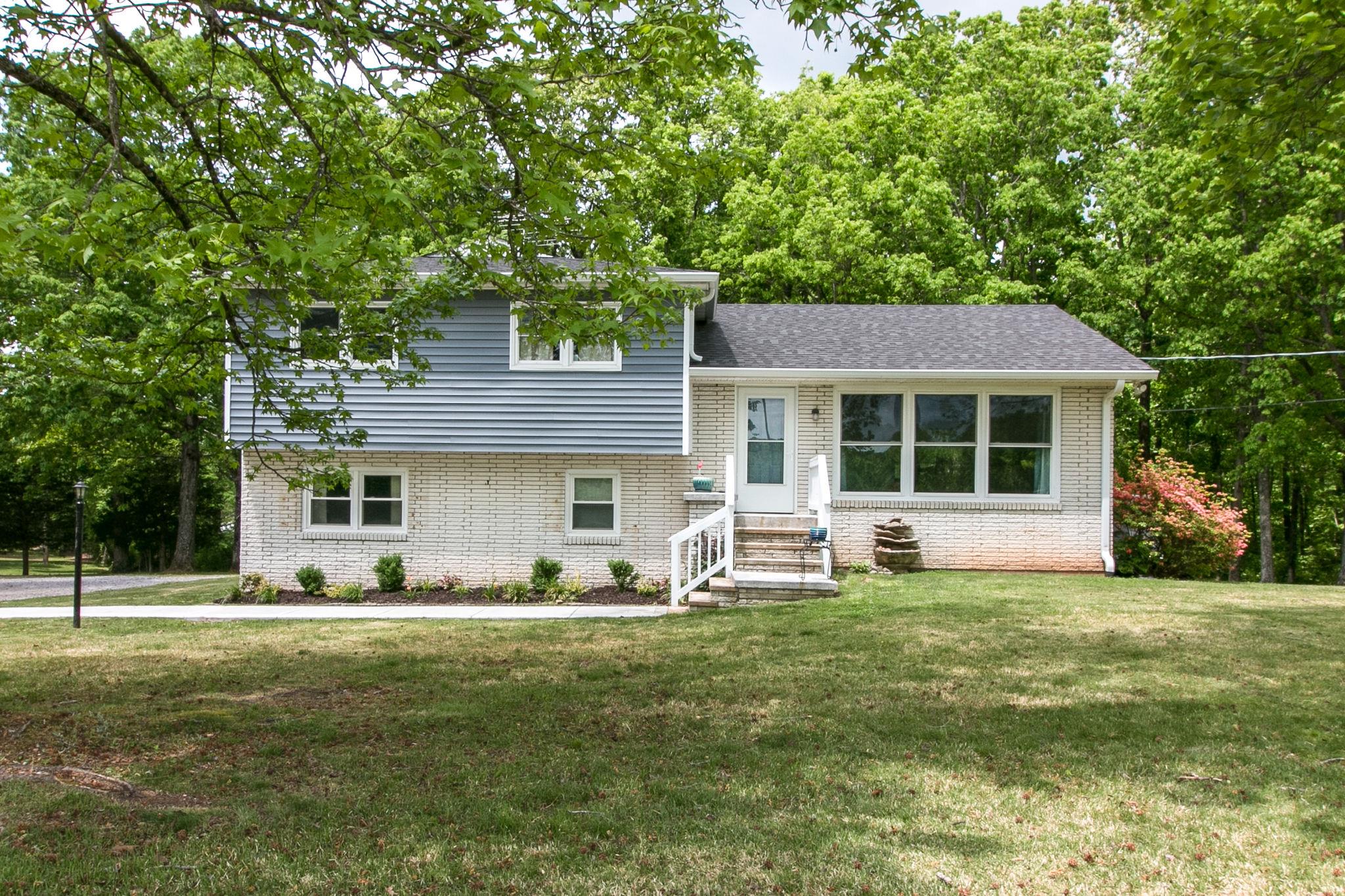 330 Cooley Ford Road Tennessee Ridge, TN 37178 - Photo 1 of 29 a front view of a house with a yard and trees