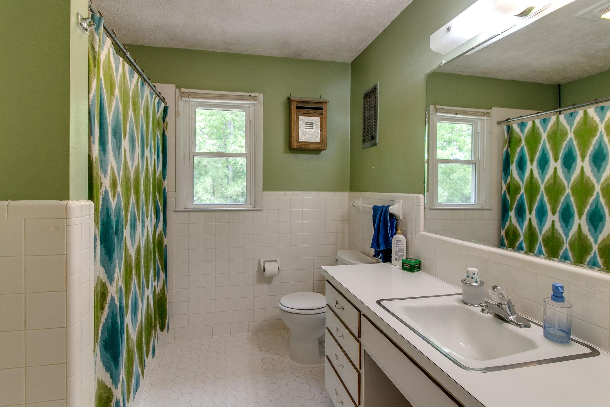 330 Cooley Ford Road Tennessee Ridge, TN 37178 - Photo 16 of 29 a bathroom with a sink a toilet and mirror
