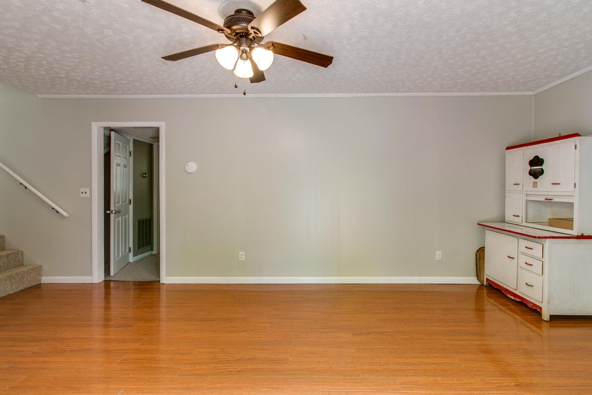 330 Cooley Ford Road Tennessee Ridge, TN 37178 - Photo 19 of 29 a view of a kitchen with wooden floor and a ceiling fan