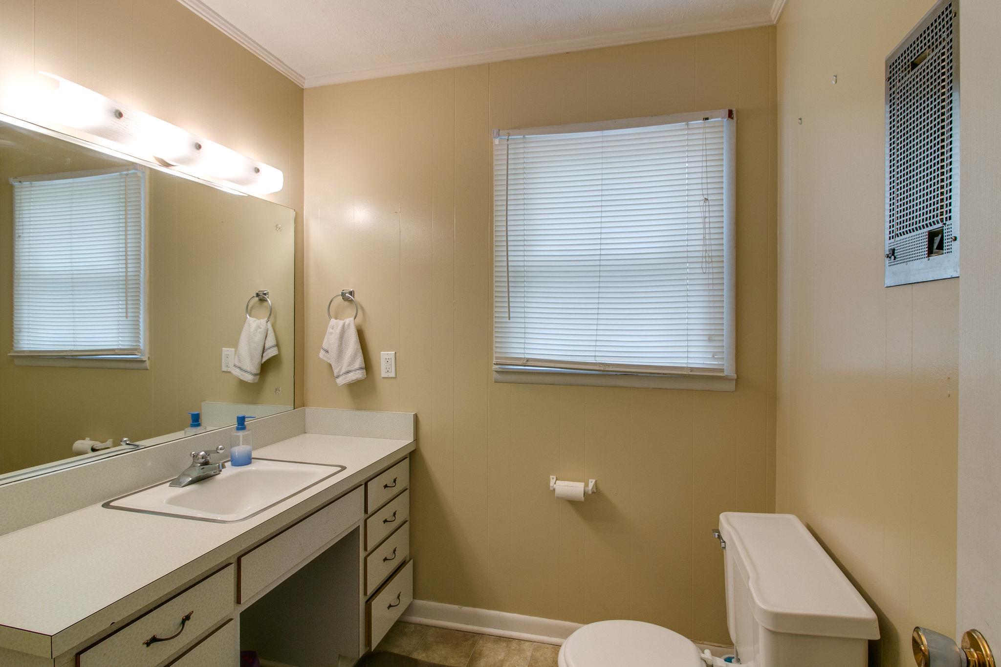 330 Cooley Ford Road Tennessee Ridge, TN 37178 - Photo 20 of 29 a bathroom with a granite countertop sink mirror and toilet