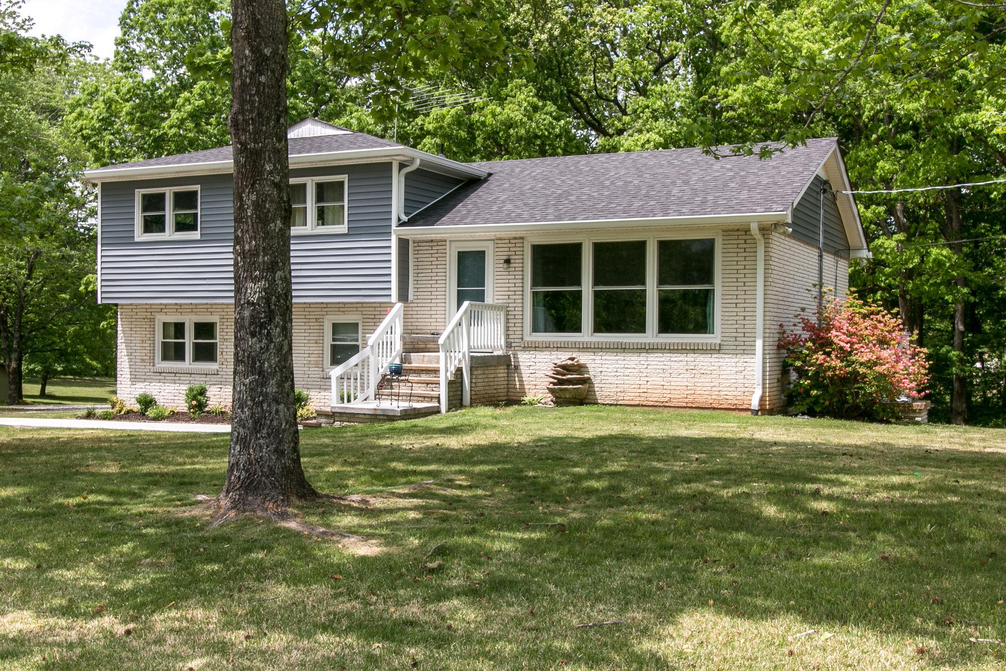 330 Cooley Ford Road Tennessee Ridge, TN 37178 - Photo 3 of 29 a front view of a house with a yard and garage