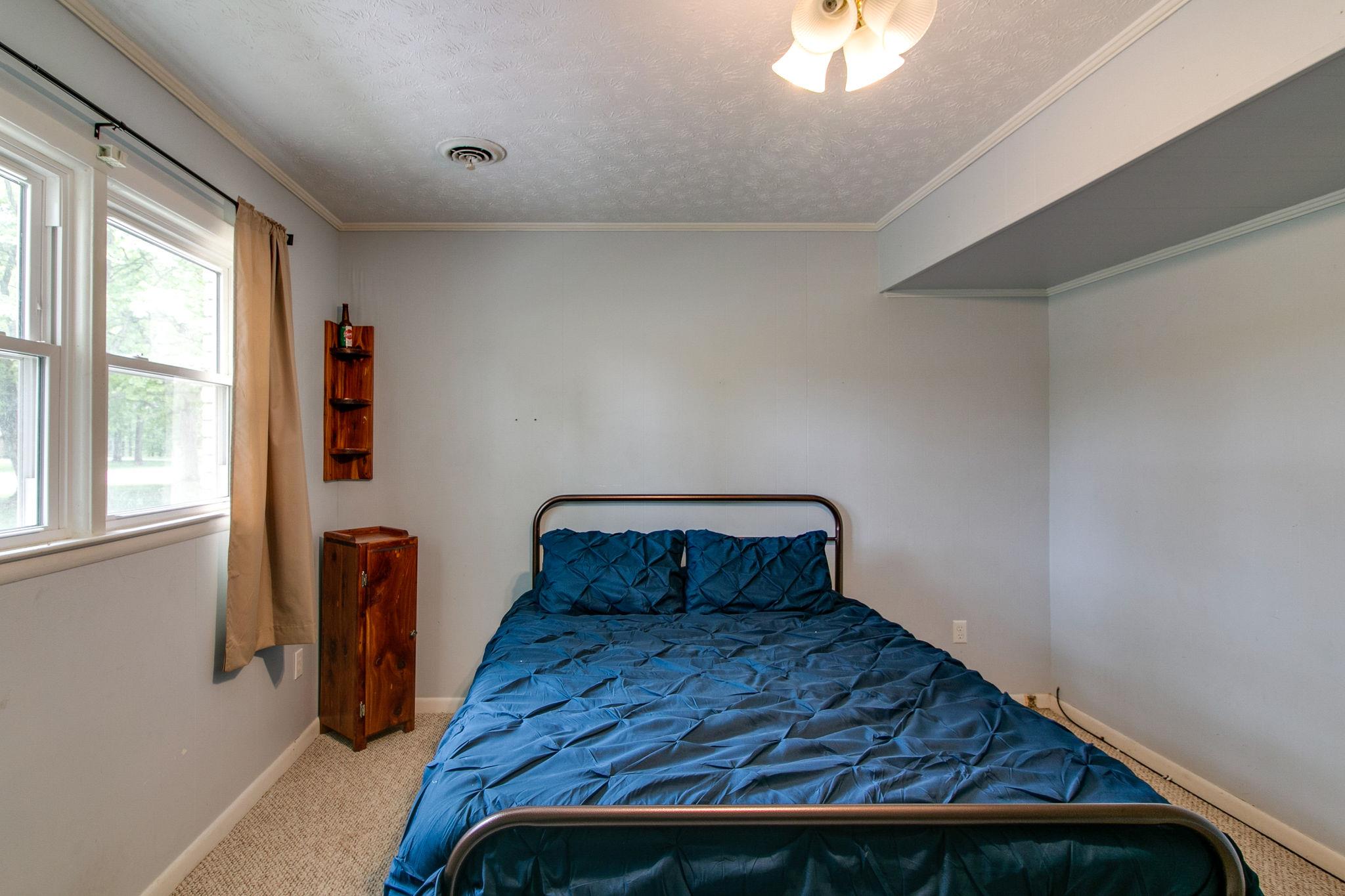 330 Cooley Ford Road Tennessee Ridge, TN 37178 - Photo 22 of 29 a bedroom with a bed and wooden floor