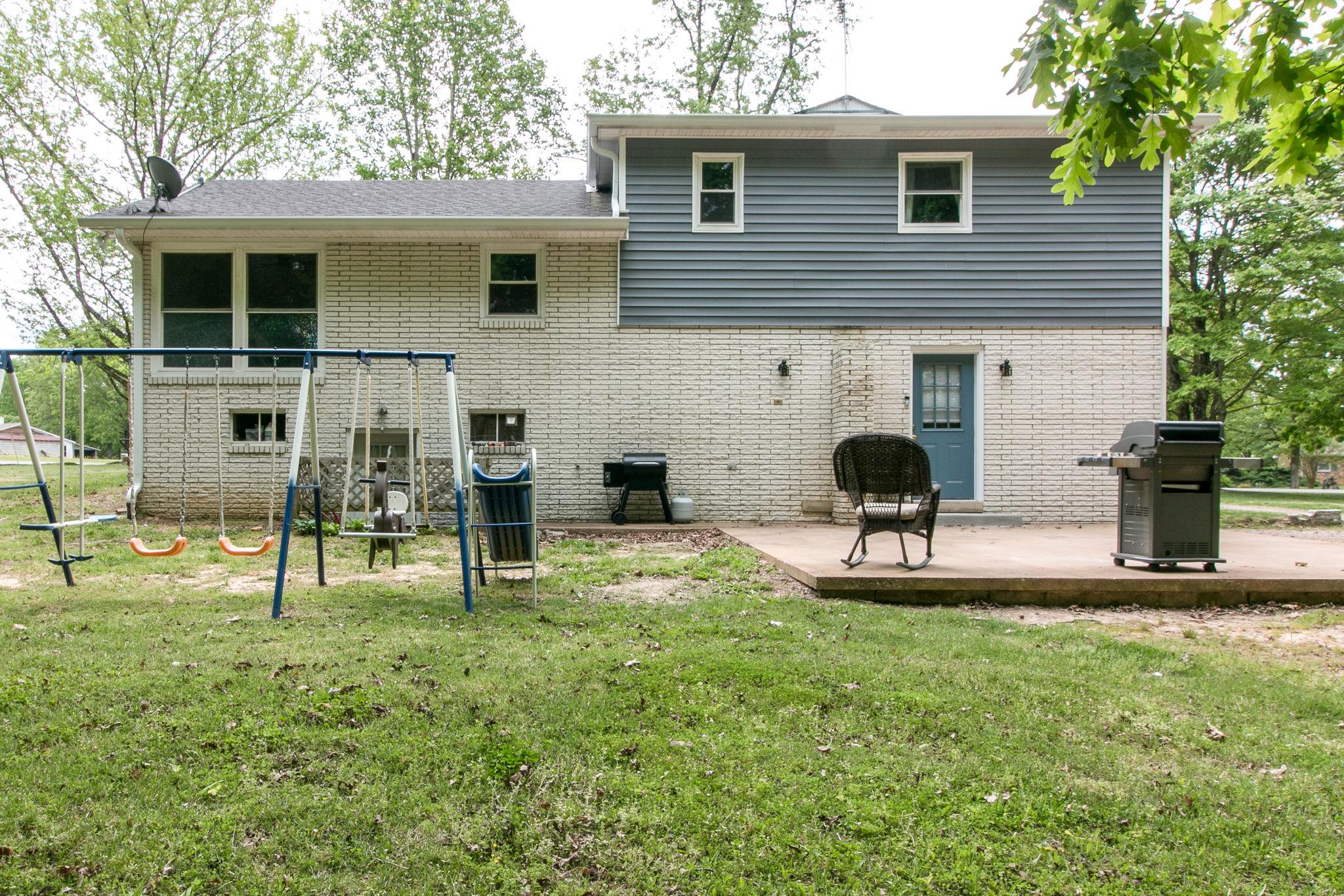 330 Cooley Ford Road Tennessee Ridge, TN 37178 - Photo 28 of 29 a view of a chair and table in backyard of the house
