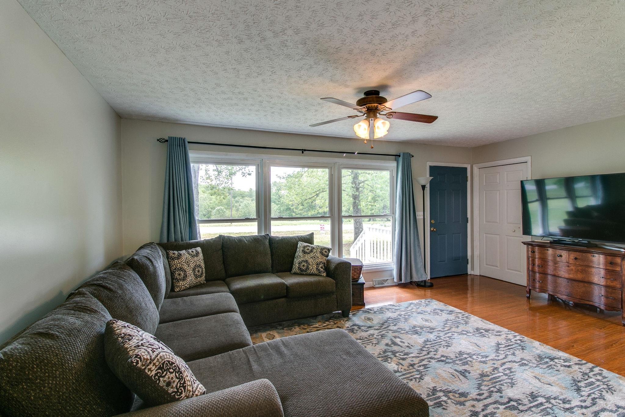 330 Cooley Ford Road Tennessee Ridge, TN 37178 - Photo 6 of 29 a living room with furniture ceiling fan and a flat screen tv