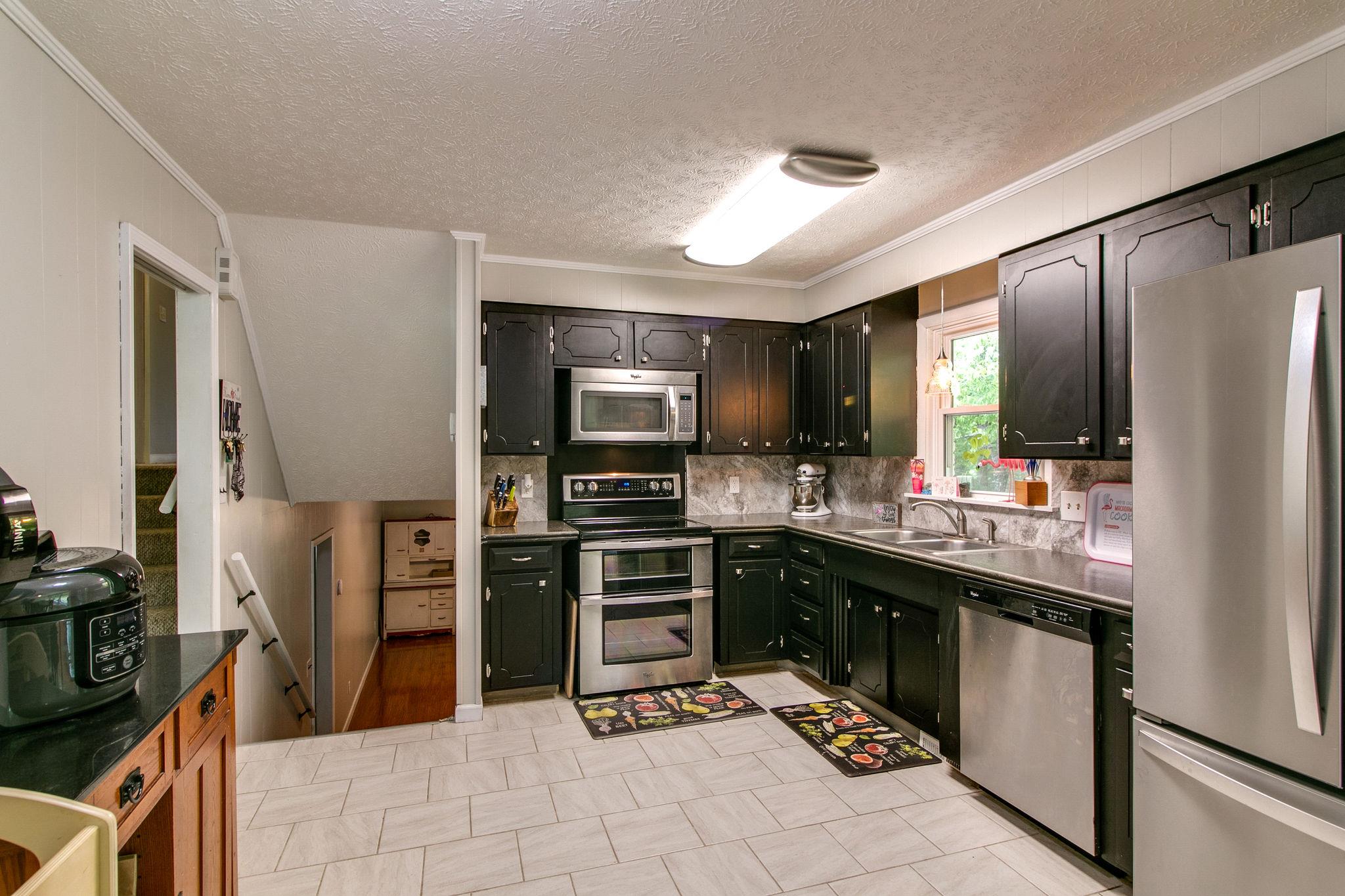 330 Cooley Ford Road Tennessee Ridge, TN 37178 - Photo 8 of 29 a kitchen with stainless steel appliances a stove refrigerator sink and microwave