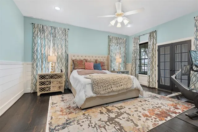 a bedroom with a large bed and a chandelier