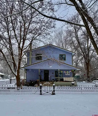 a front view of a house with a bench
