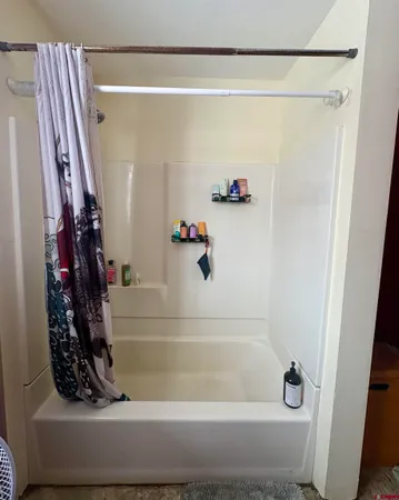 a room with wooden floor and windows