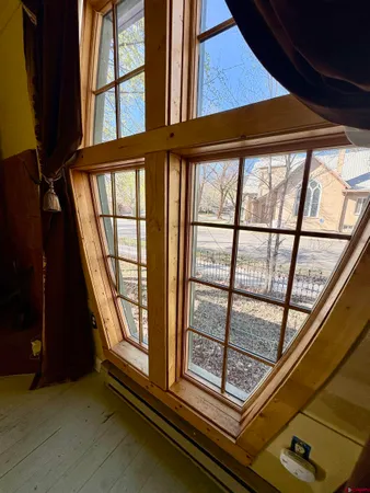 a bedroom with furniture and a large window