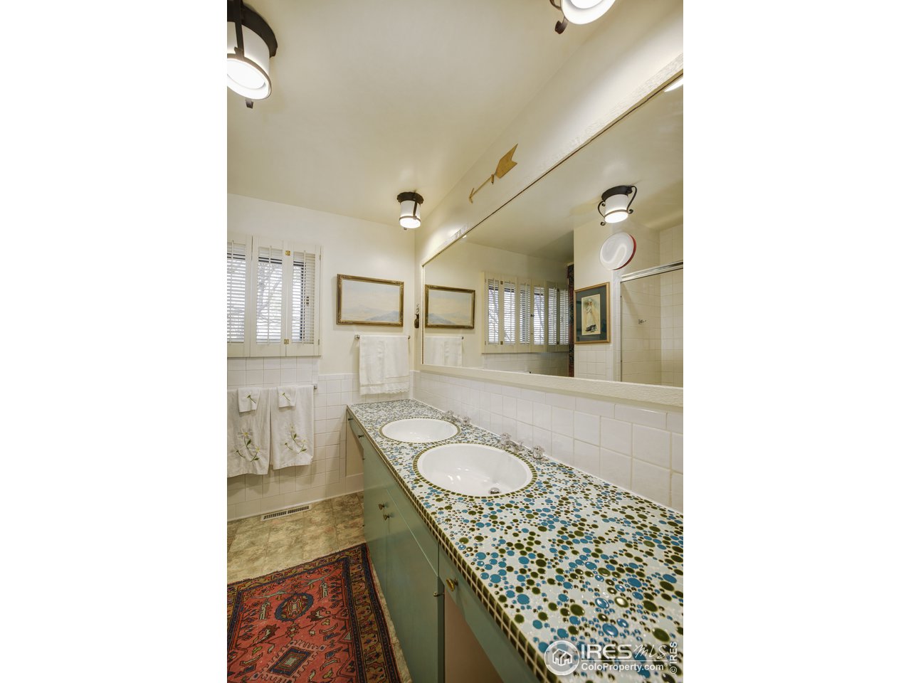 550 13th Street Boulder, CO 80302 - Photo 13 of 26 a bathroom with a granite countertop sink and a mirror