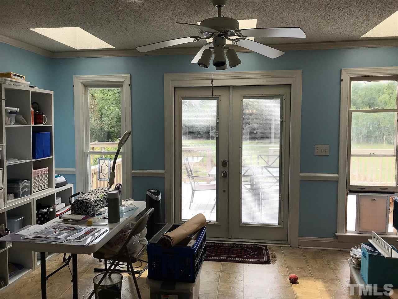 841 Pilot-Riley Road Zebulon, NC 27597 - Photo 7 of 29 a workspace with furniture a chandelier and window