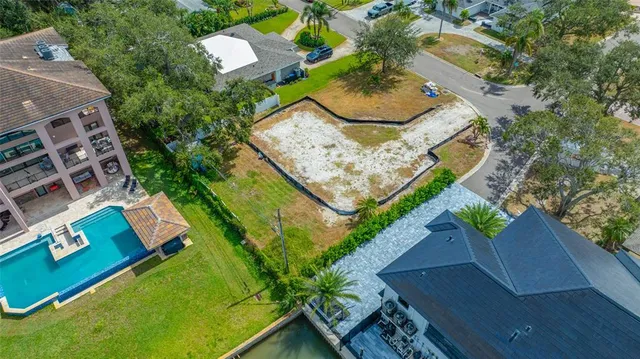 an aerial view of a house a yard and lake view